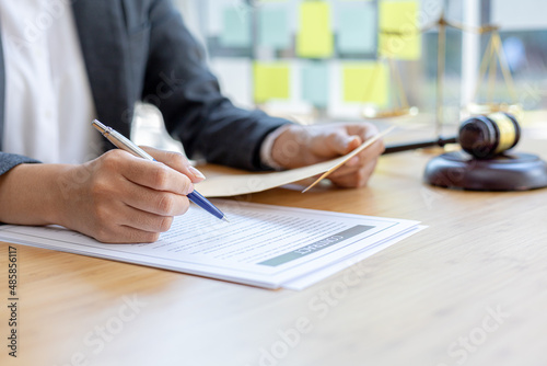 Photos Attorneys are reviewing contract documents for the client, in which the client has filed a lawsuit against an employee at a company that commits the fraud