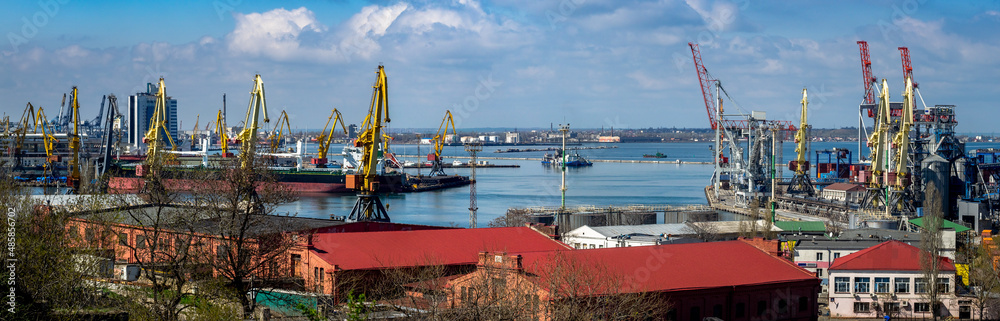 Panorama of Odessa Cargo Port with warehouses, port cranes and Industrial infrastructure of commercial seaport, wide landscape.