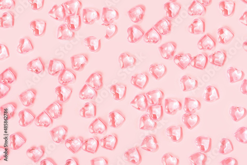 St Valentines day pink monochrome background full frame. Many glass hearts flat lay. Love or wedding concept