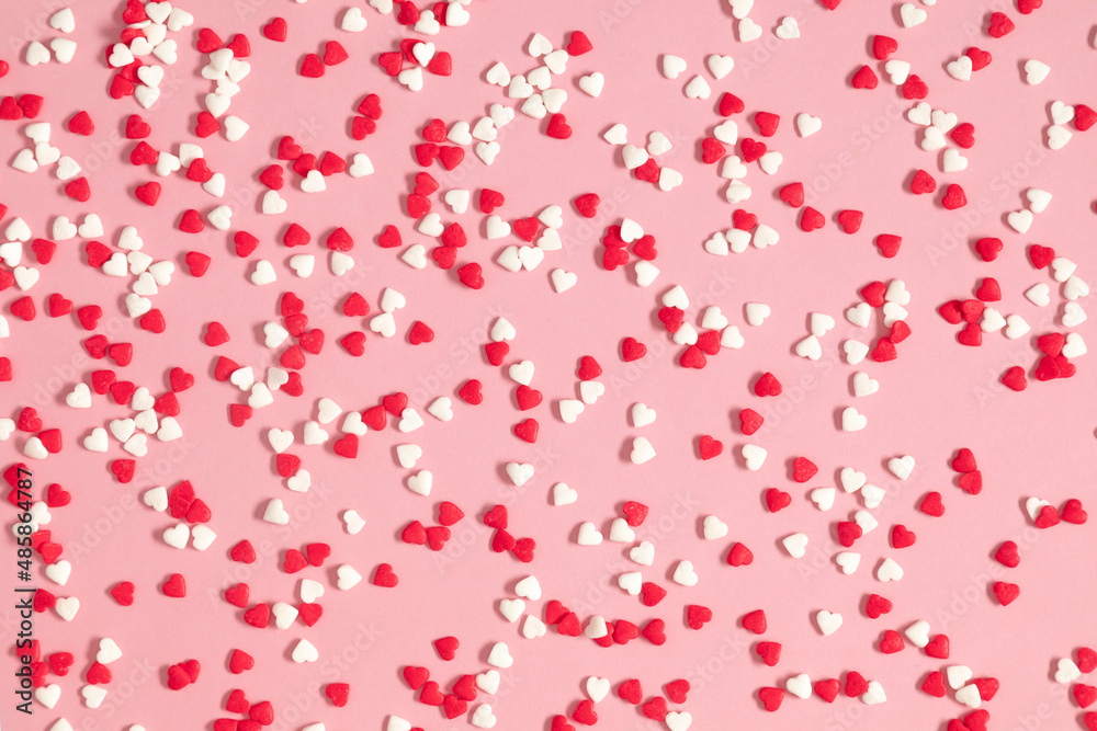 Valentine's Day pattern background. Composition with candy hearts. Symbol heart of sweets on pastel pink background. Flat lay, top view Valentine's Day pattern background. Composition with candy hearts. Symbol heart of sweets on pastel pink background. Flat lay, top view