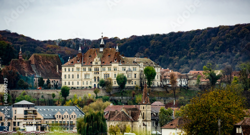Ancient Sighisoara city in Romania, panoramic old clock tower, castle and medieval architecture view. Historic european town with Dracula house photo
