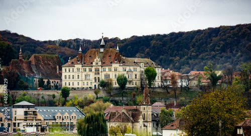 Ancient Sighisoara city in Romania, panoramic old clock tower, castle and medieval architecture view. Historic european town with Dracula house