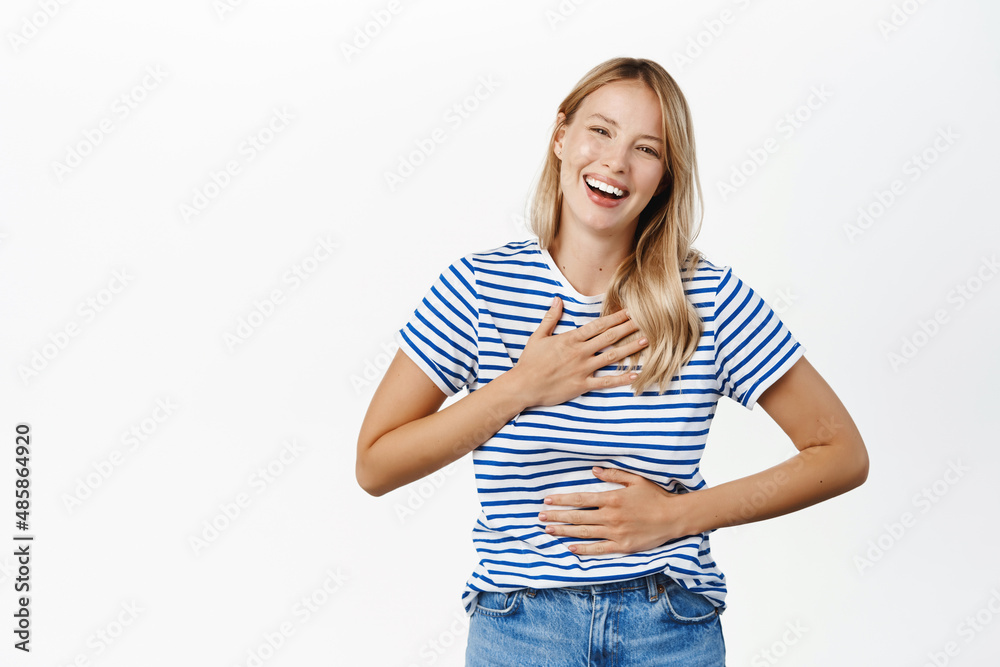 Portrait of stylish modern woman with natural face expression, laughing and smiling over smth funny, watching comedy, standing over white background Portrait of stylish modern woman with natural face expression, laughing and smiling over smth funny, watching comedy, standing over white background