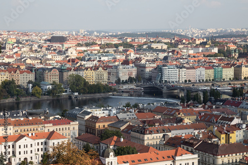 Prague cityscape panoramic beautiful aerial view above the rooftops. Prague city center, view at river Vltava and rooftop buildings in the capital city of Czech Republic.