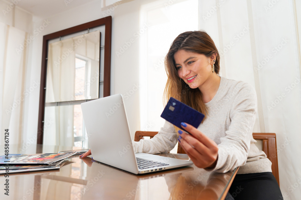 happy young woman shopping online with credit card from home. High quality photo happy young woman shopping online with credit card from home. High quality photo