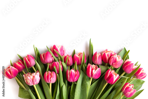 Fototapeta Naklejka Na Ścianę i Meble -  Bouquet of pink tulips on white background. Mothers day, Valentines Day, Birthday celebration concept. Greeting card. Copy space for text, top view
