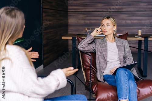 Smart attractive woman professional attentively listens to the client.