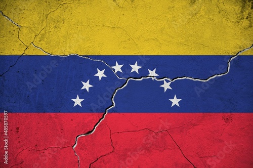 An image of the Venezuela flag on a wall with a crack.