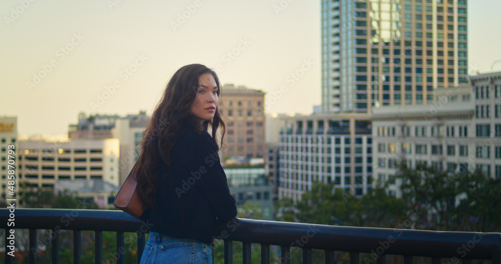 Attractive woman look around standing on cityscape. Asian girl waiting someone.