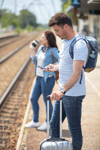 beautiful couple parting at train station