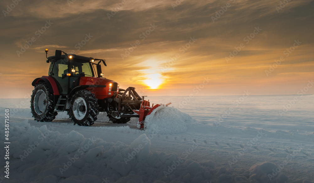 Tractor cleaning snow in field Tractor cleaning snow in field