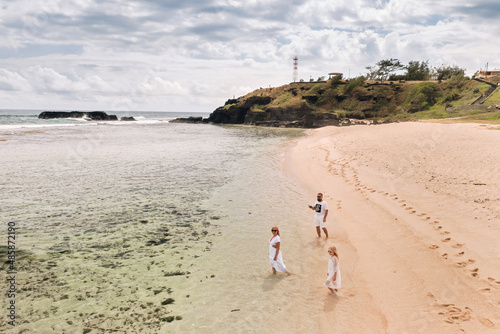 A family walks on Gris Gris beach in southern Mauritius in the Indian Ocean photo