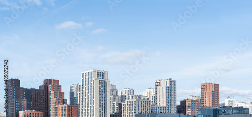 Panorama of new residential district of Moscow. Modern architecture of apartment buildings. Horizontal banner with clear blue sky. Russia.