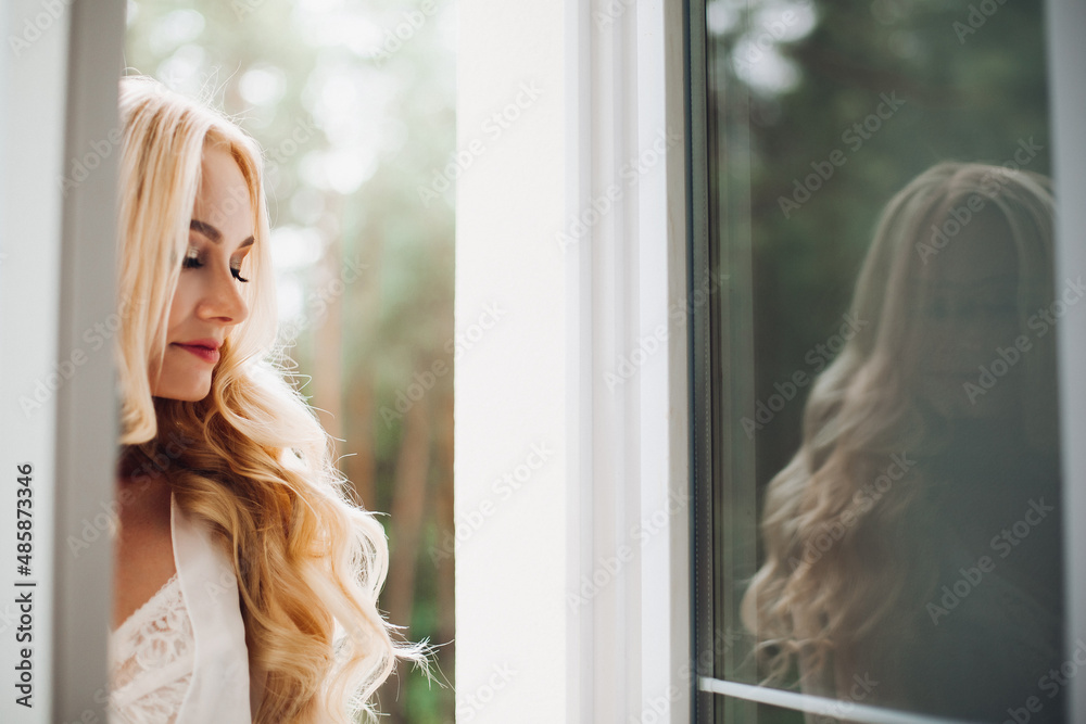 Gorgeous blondie bride walking at balcony and waiting for her groom. Gorgeous blondie bride walking at balcony and waiting for her groom.