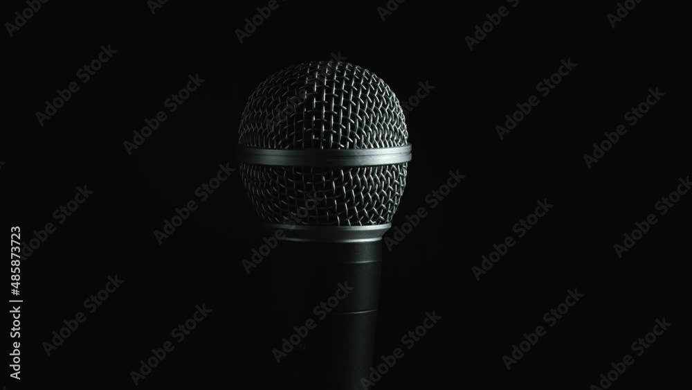 Microphone with moving light on black background Microphone with moving light on black background