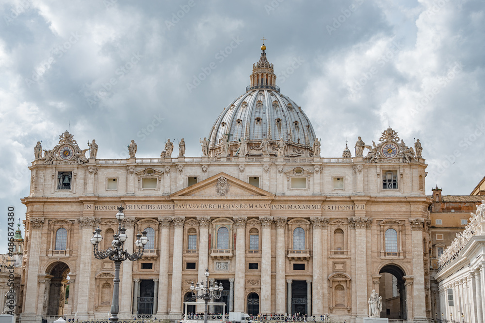 Dramatic view over Saint Peter Basilica in Vatican city, in the center of Rome, Italy, with heavy clouds.