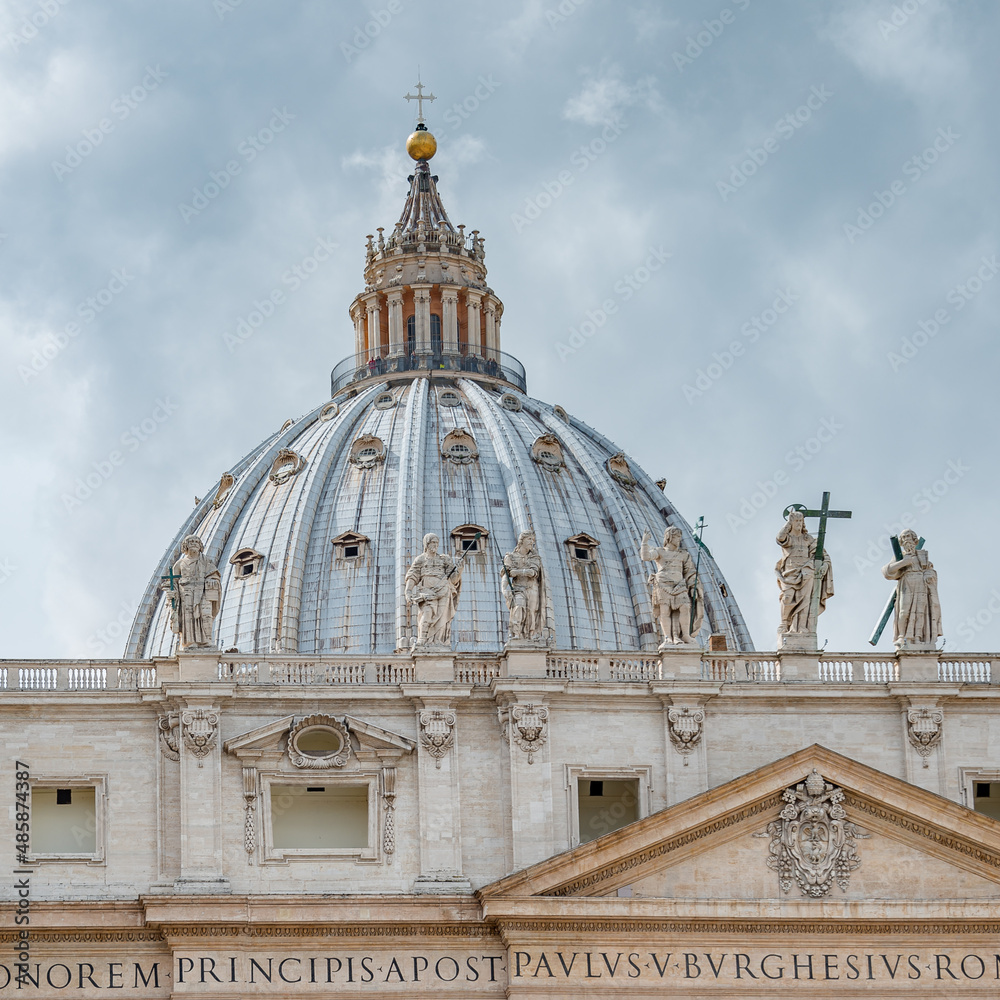 Dramatic view over Saint Peter Basilica in Vatican city, in the center of Rome, Italy, with heavy clouds.