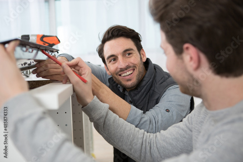 instructor and apprentice looking at appliance