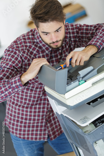 man mending the photocopier