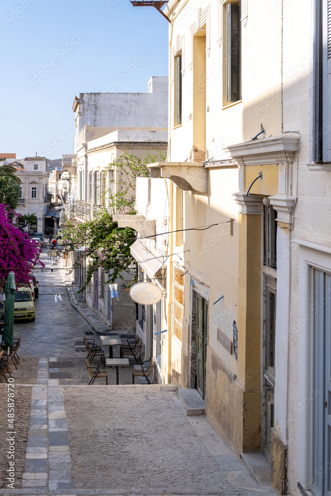 Obraz premium Greece. Ermoupolis Syros island, Narrow street, traditional architecture and bougainvillea