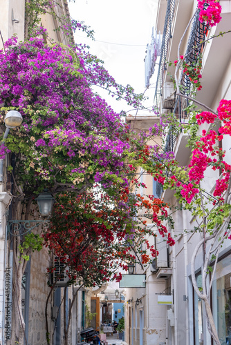 Greece. Ermoupolis Syros island, Narrow street, traditional architecture and bougainvillea