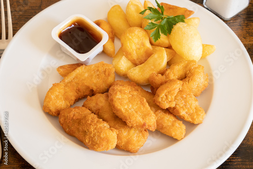 chicken nuggets with fries and barbecue sauce