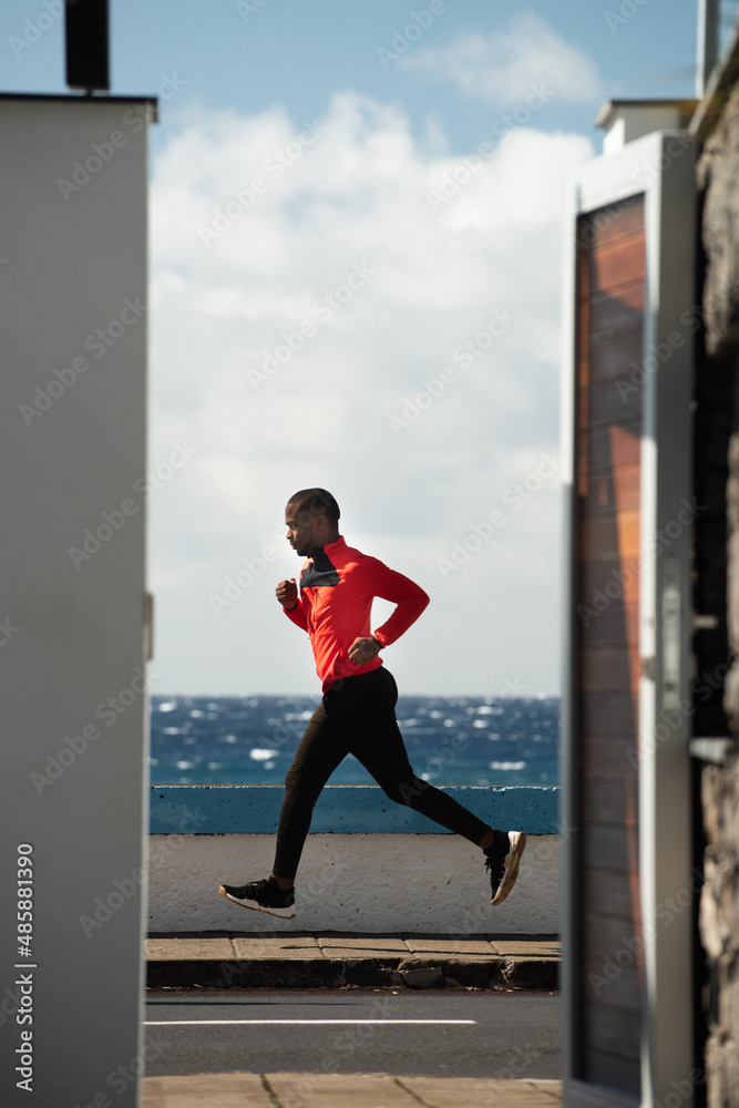 Full body portrait African american man running by street Full body portrait African american man running by street