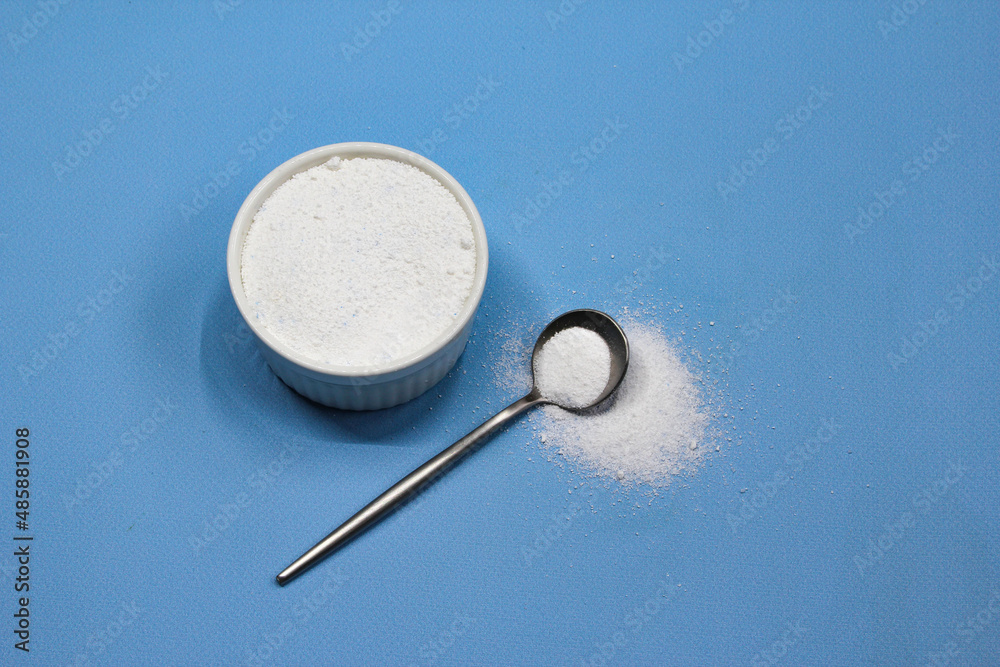 Collagen powder on blue background. Natural health supplement for skin