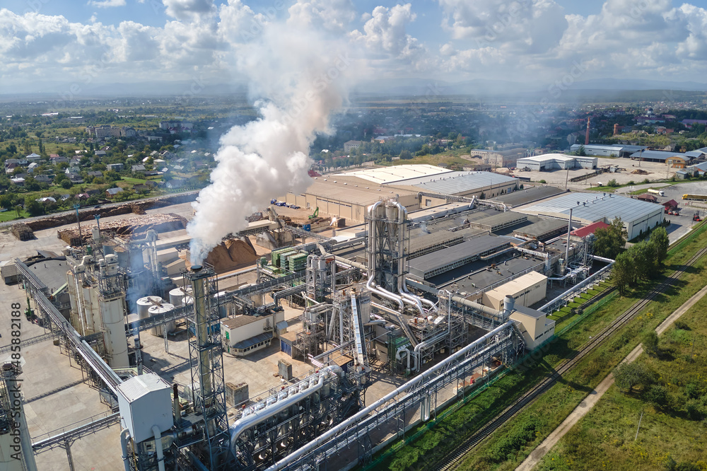 Aerial view of oil and gas refining petrochemical factory with high refinery plant manufacture structure. Global production and manufacturing concept