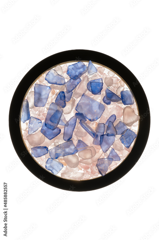 Sea glass, teal, pink, salmon, blue colored stones and tile pieces on white background with circle element. Sea glass, teal, pink, salmon, blue colored stones and tile pieces on white background with circle element.
