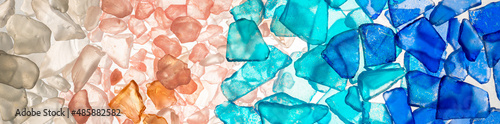 Sea glass, teal, pink, salmon, blue colored stones and tile pieces on white background.  Long gradient color rainbow.