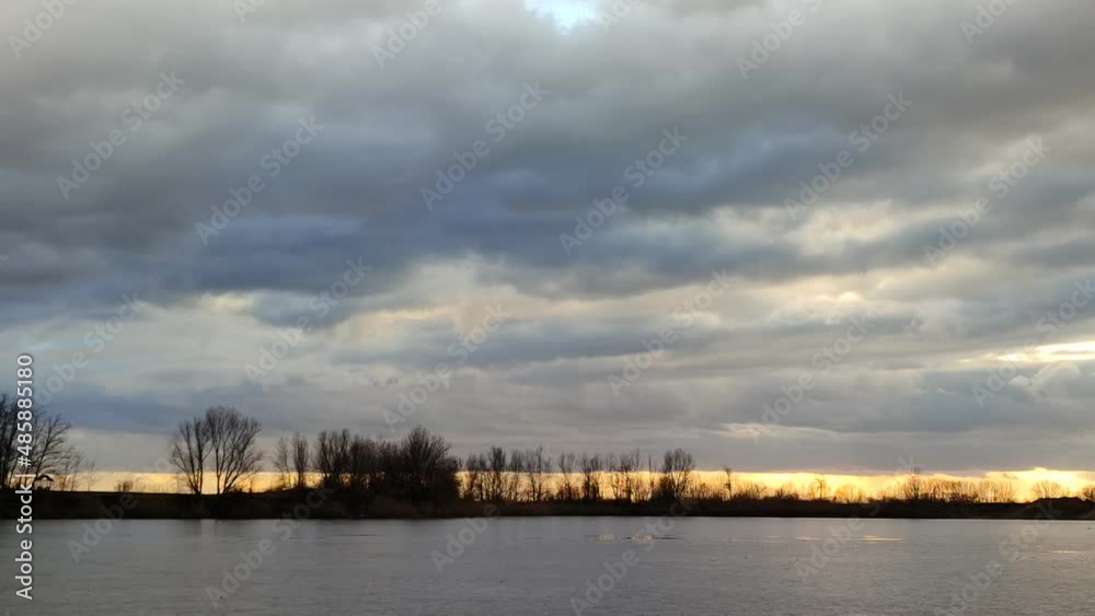 Afternoon clouds above the frozen lake. 4K time lapse. Afternoon clouds above the frozen lake. 4K time lapse.