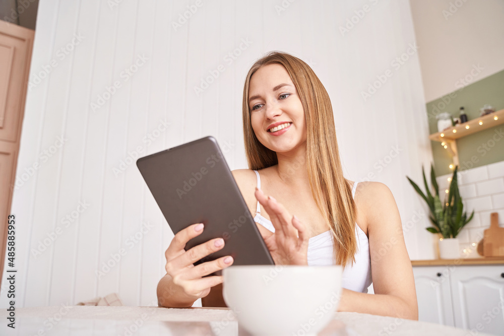 Young woman working indoors. Home vacation portrait. Blogger. Alone in interior. Happy emotion. Smiling female person. Lifestyle action sitting on couch Young woman working indoors. Home vacation portrait. Blogger. Alone in interior. Happy emotion. Smiling female person. Lifestyle action sitting on couch