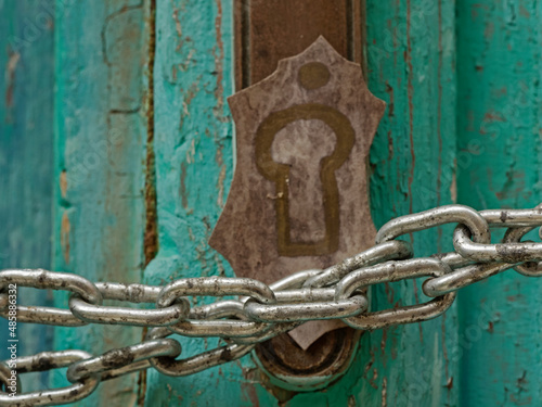 Chained old turquoise wooden door