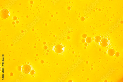 Orange juice. Bubble yellow texture background. Berry gel to cleanse the skin of the face and body. Spa treatments, skin care. Bath foam, detergent. Gold slime