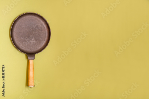 Cast-iron pancake pan with wooden handle. Pancake day. Space for text. copy space.