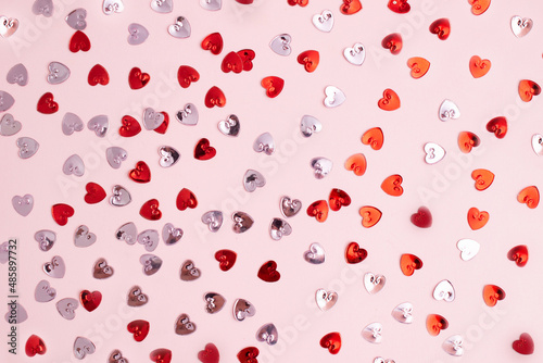 Pattern with red and rose confetti hearts.