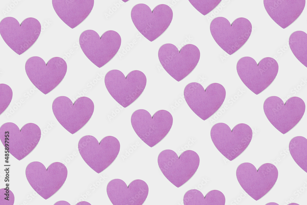 Pattern made of pastel purple heart shape on bright white background. Element of pure love. Minimal valentines concept. Romantic wallpaper idea.