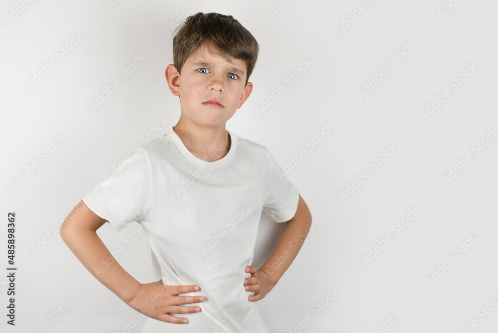 Young boy with emotions of sadness, depression on his face. Portrait of a sad boy 6-8 years old on a light background, the boy needs help and hugs from his parents Young boy with emotions of sadness, depression on his face. Portrait of a sad boy 6-8 years old on a light background, the boy needs help and hugs from his parents