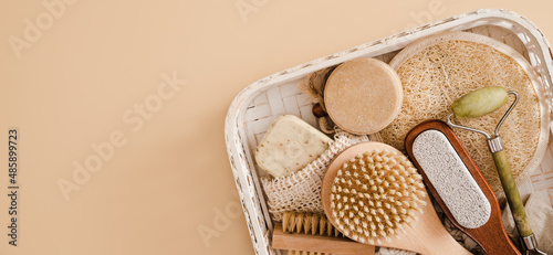 Flat lay composition with zero waste eco friendly cosmetics and bathroom accessories on beige background. Skin care concept. Face care routine. Hard soap and peeling accesories