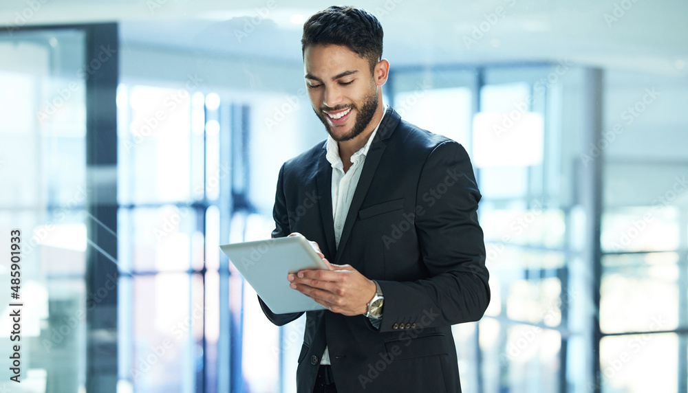 Having a digital tablet makes life more convenient. Shot of a young businessman using a digital tablet. Having a digital tablet makes life more convenient. Shot of a young businessman using a digital tablet.