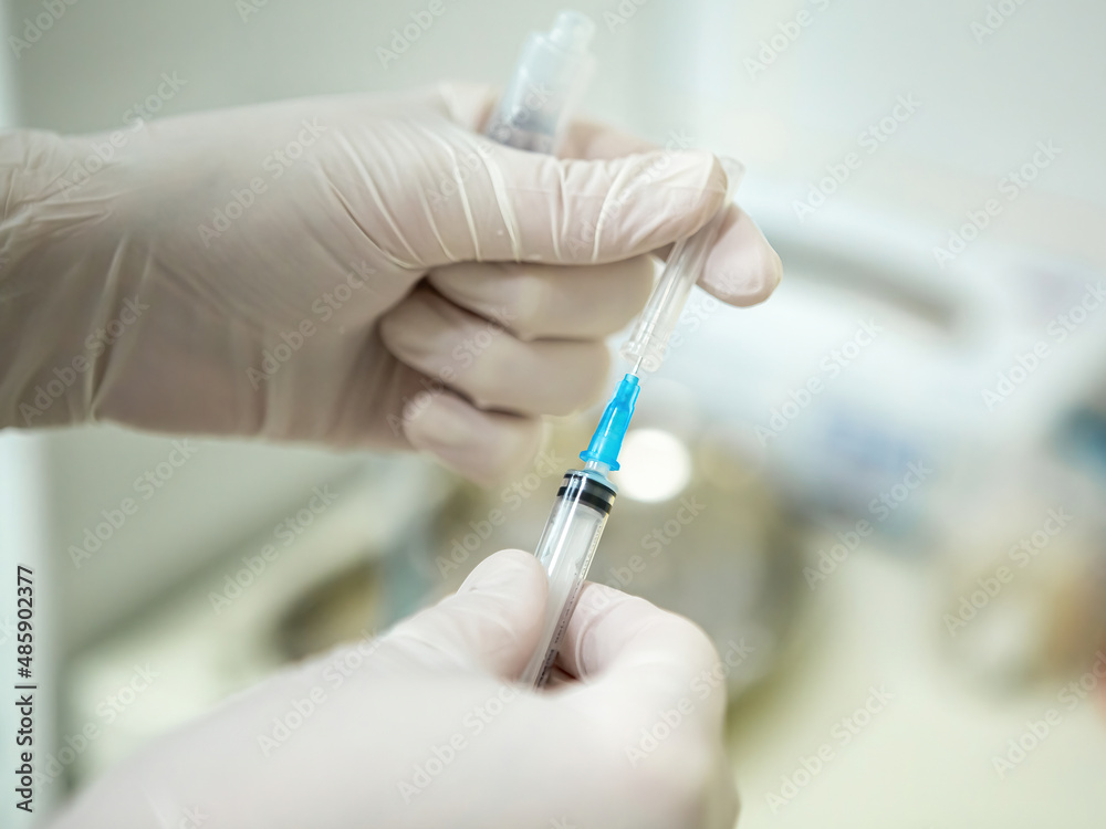 Infusion syringe in the hands of a nurse. Selective focus Infusion syringe in the hands of a nurse. Selective focus