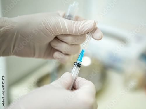 Infusion syringe in the hands of a nurse. Selective focus