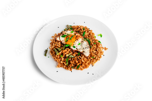 Hot fresh noodles with fried egg isolated on a white background.