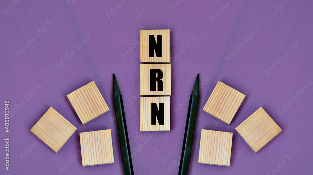 NRN - acronym on wooden cubes with pencils on a purple background NRN - acronym on wooden cubes with pencils on a purple background