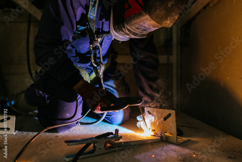 Closeup shot of a Caucasian male from Spain welding metal in construction site