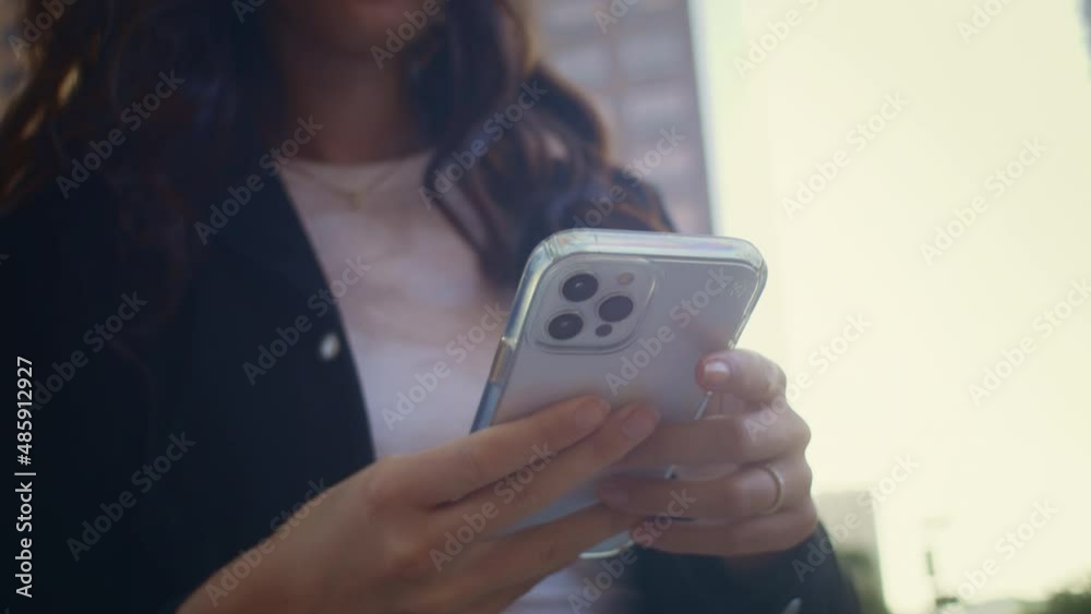 Unknown woman hands holding modern smartphone close up. Girl use phone outdoors