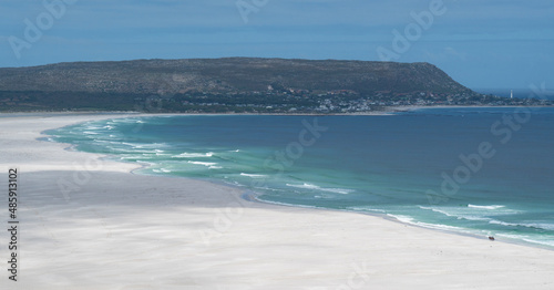 Two isolated horse riders on Noordhoek, Long Beach, South Africa. photo