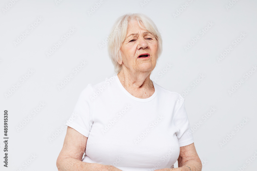 Photo of retired old lady in a white t-shirt isolated background Photo of retired old lady in a white t-shirt isolated background