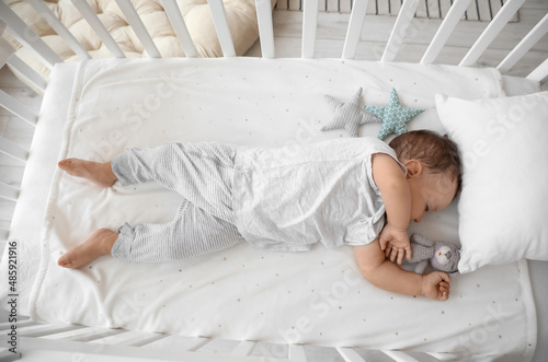 Adorable baby with toy slee...